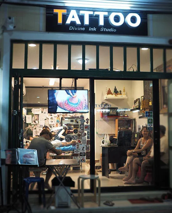 The entrance and interior of Divine Ink Tattoo Studio on Khaosan Road