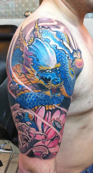 Blue, pink and orange sleeve tattoo