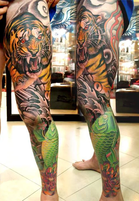 Colour tiger and botanical leg tattoo